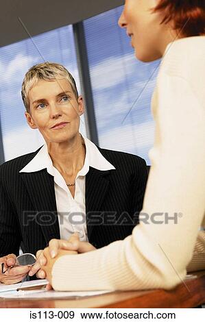 Stock Photo - Businesswomen meeting in office. Fotosearch