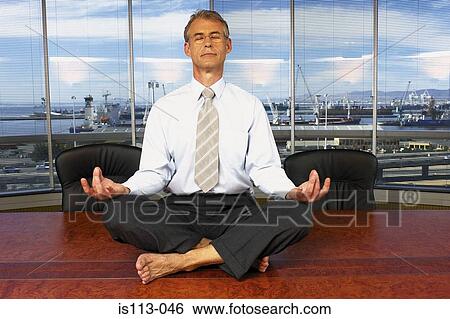 Stock Photograph - Meditating businessman. Fotosearch