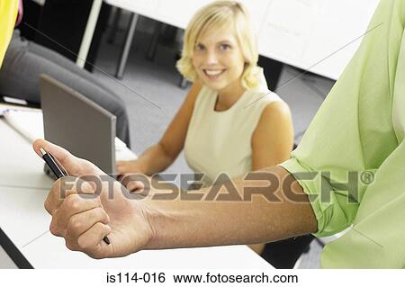 Stock Photograph - Businessman and businesswoman in office. Fotosearch