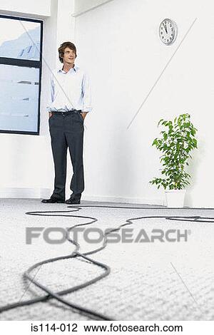 Businessman in empty office View Large Photo Image Stock Image - Businessman in empty office. Fotosearch