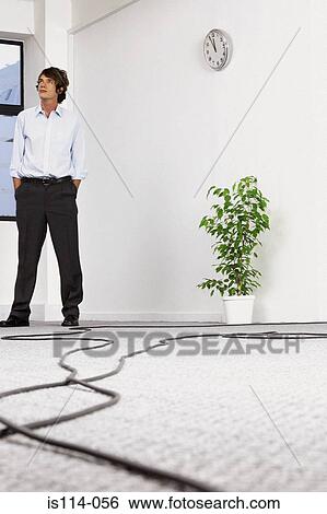 Businessman in empty office View Large Photo Image Stock Photograph - Businessman in empty office. Fotosearch