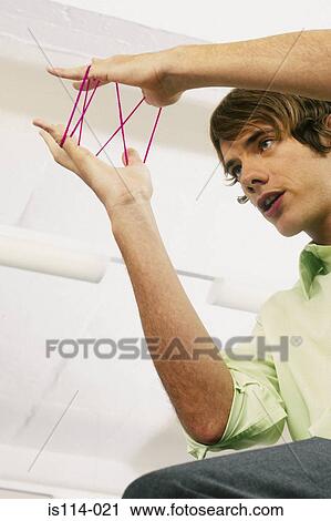 Businessman playing with elastic band View Large Photo Image Stock Image - Businessman playing with elastic band. Fotosearch