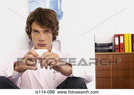 Businessman sitting next to mineral water View Large Photo Image Stock Photo - Businessman sitting next to mineral water. Fotosearch