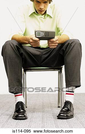 Businessman using cellphone View Large Photo Image Stock Photography - Businessman using cellphone. Fotosearch