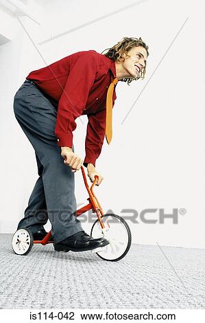 Businessman with baby bicycle View Large Photo Image Stock Image - Businessman with baby bicycle. Fotosearch