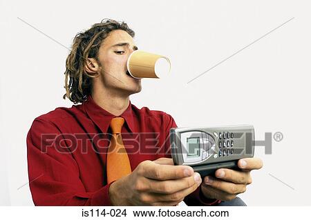 Picture - Businessman with coffee and cellphone. Fotosearch