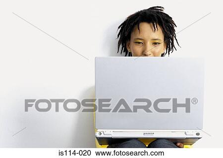 Stock Image - Businesswoman with laptop computer. Fotosearch