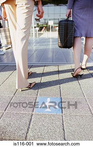 Stock Image - Business colleagues at airport terminal. Fotosearch