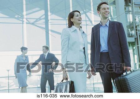 Stock Photography - Business colleagues in airport terminal. Fotosearch
