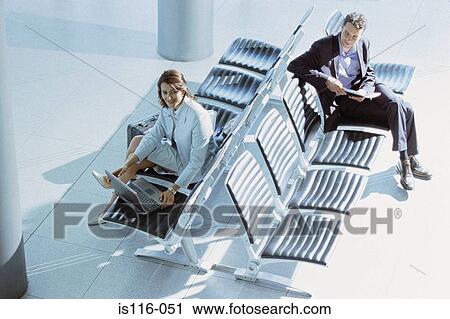 Businessman and businesswoman meeting in airport lounge View Large Photo Image Stock Image - Businessman and businesswoman meeting in airport lounge. Fotosearch