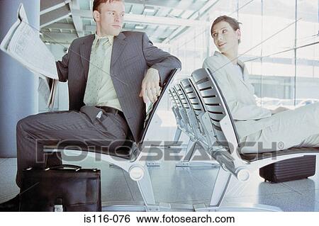 Businessman and businesswoman meeting in airport lounge View Large Photo Image Stock Photograph - Businessman and businesswoman meeting in airport lounge. Fotosearch