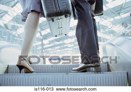 Businessman and businesswoman on airport elevator View Large Photo Image Stock Image - Businessman and businesswoman on airport elevator. Fotosearch