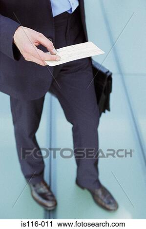 Businessman checking airline ticket View Large Photo Image Stock Image - Businessman checking airline ticket. Fotosearch