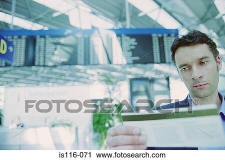 Businessman checking airline ticket View Large Photo Image Stock Image - Businessman checking airline ticket. Fotosearch