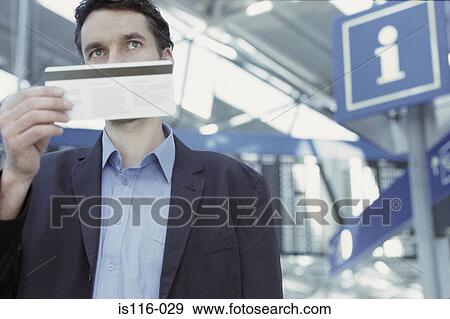 Stock Photo - Businessman checking airline ticket. Fotosearch