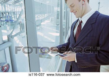 Businessman checking airline ticket View Large Photo Image Stock Photo - Businessman checking airline ticket. Fotosearch