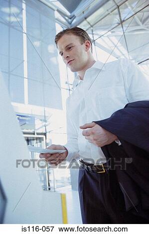 Businessman checking airline ticket View Large Photo Image Stock Photo - Businessman checking airline ticket. Fotosearch