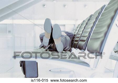 Businessman relaxing in airport lounge View Large Photo Image Stock Photography - Businessman relaxing in airport lounge. Fotosearch