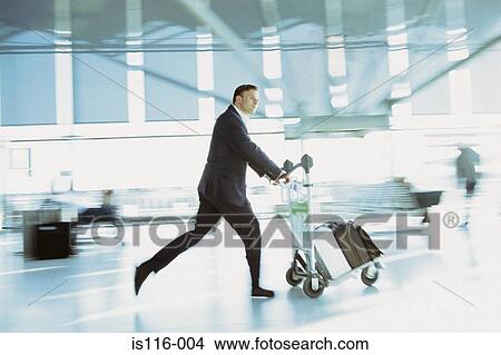 Businessman rushing in airport terminal View Large Photo Image Picture - Businessman rushing in airport terminal. Fotosearch