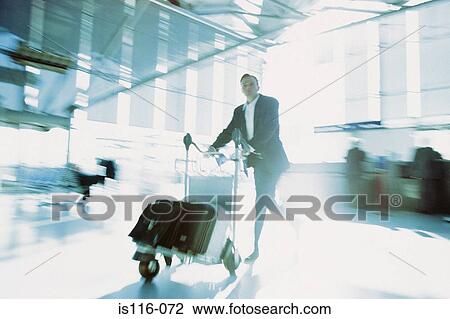 Businessman rushing in airport terminal View Large Photo Image Stock Image - Businessman rushing in airport terminal. Fotosearch