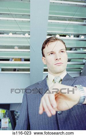 Stock Image - Businessman waiting in airport lounge. Fotosearch