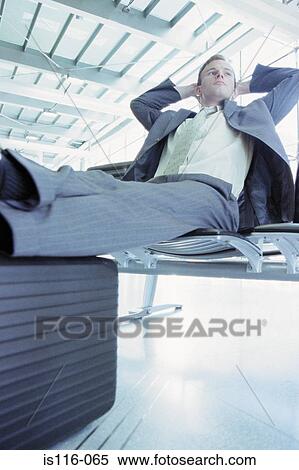 Businessman waiting in airport lounge View Large Photo Image Stock Photography - Businessman waiting in airport lounge. Fotosearch