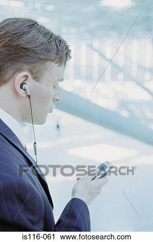 Businessman with cellphone at airport View Large Photo Image Stock Image - Businessman with cellphone at airport . Fotosearch