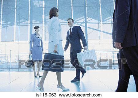 Businesspeople in airport terminal View Large Photo Image Stock Image - Businesspeople in airport terminal. Fotosearch
