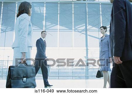 Stock Photo - Businesspeople in airport terminal. Fotosearch