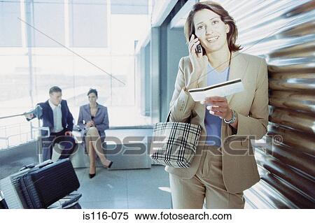 Businesswoman checking airline ticket View Large Photo Image Stock Photography - Businesswoman checking airline ticket. Fotosearch