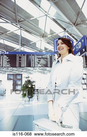 Businesswoman in airport terminal View Large Photo Image Stock Photo - Businesswoman in airport terminal. Fotosearch