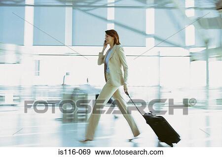 Businesswoman in airport terminal View Large Photo Image Stock Photo - Businesswoman in airport terminal. Fotosearch