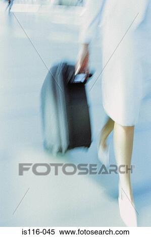 Businesswoman in airport terminal View Large Photo Image Stock Photography - Businesswoman in airport terminal. Fotosearch
