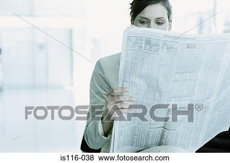Businesswoman reading a paper in airport terminal View Large Photo Image Stock Photo - Businesswoman reading a paper in airport terminal. Fotosearch