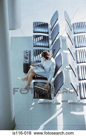 Businesswoman waiting in airport lounge View Large Photo Image Stock Photo - Businesswoman waiting in airport lounge. Fotosearch