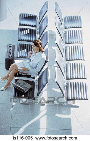 Businesswoman waiting in airport lounge View Large Photo Image Stock Photography - Businesswoman waiting in airport lounge. Fotosearch