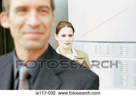 Stock Image - Businessman and businesswoman outside. Fotosearch