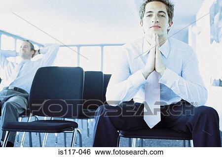 Stock Photograph - Businessman in conference hall. Fotosearch