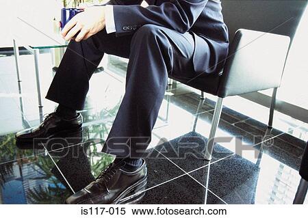 Stock Photography - Businessman sitting in modern office. Fotosearch