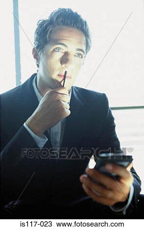 Stock Image - Businessman with palmtop. Fotosearch
