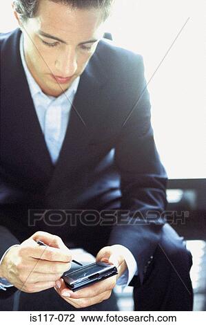 Stock Image - Businessman with palmtop. Fotosearch