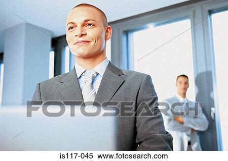 Businessman working on laptop View Large Photo Image Stock Photography - Businessman working on laptop. Fotosearch