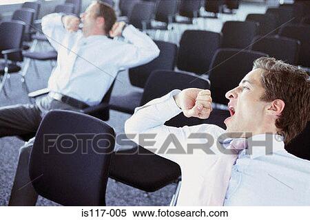 Stock Photography - Businessmen in conference hall. Fotosearch