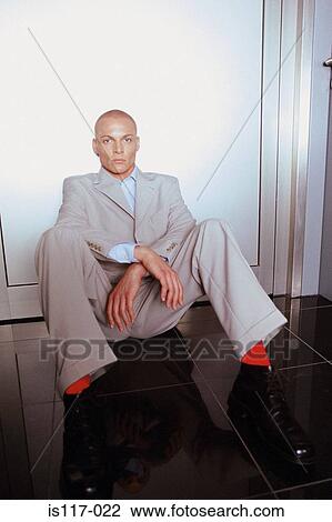 Stock Image - Businessmen sitting on floor. Fotosearch