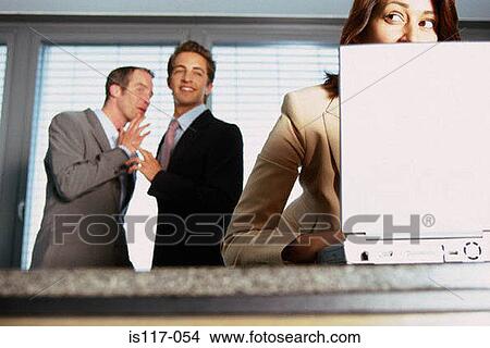 Businessmen teasing businesswoman View Large Photo Image Picture - Businessmen teasing businesswoman. Fotosearch