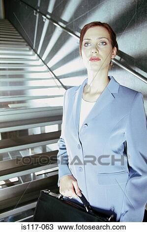 Businesswoman on modern stairway View Large Photo Image Stock Image - Businesswoman on modern stairway. Fotosearch