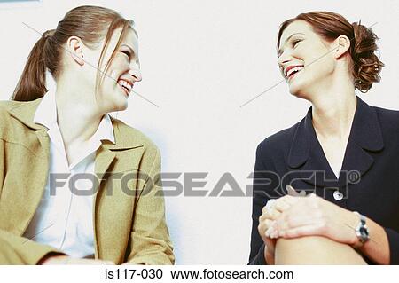 Stock Image - Businesswomen talking. Fotosearch