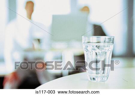 Glass of water in office View Large Photo Image Stock Image - Glass of water in office. Fotosearch
