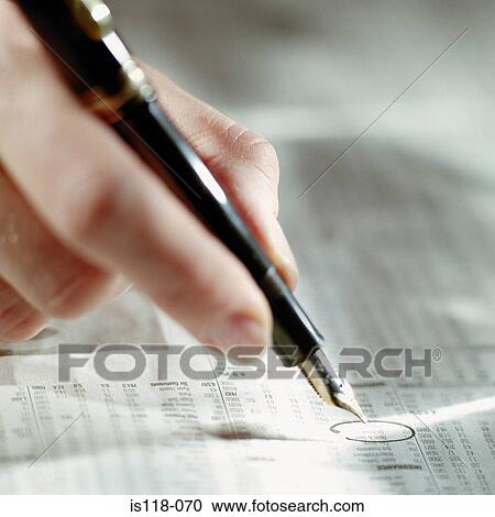 Stock Image - A hand holding a fountain pen. Fotosearch
