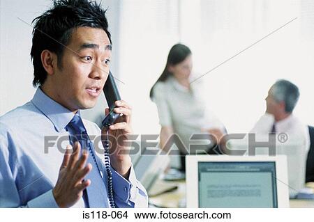 Businessman on telephone in office View Large Photo Image Picture - Businessman on telephone in office. Fotosearch